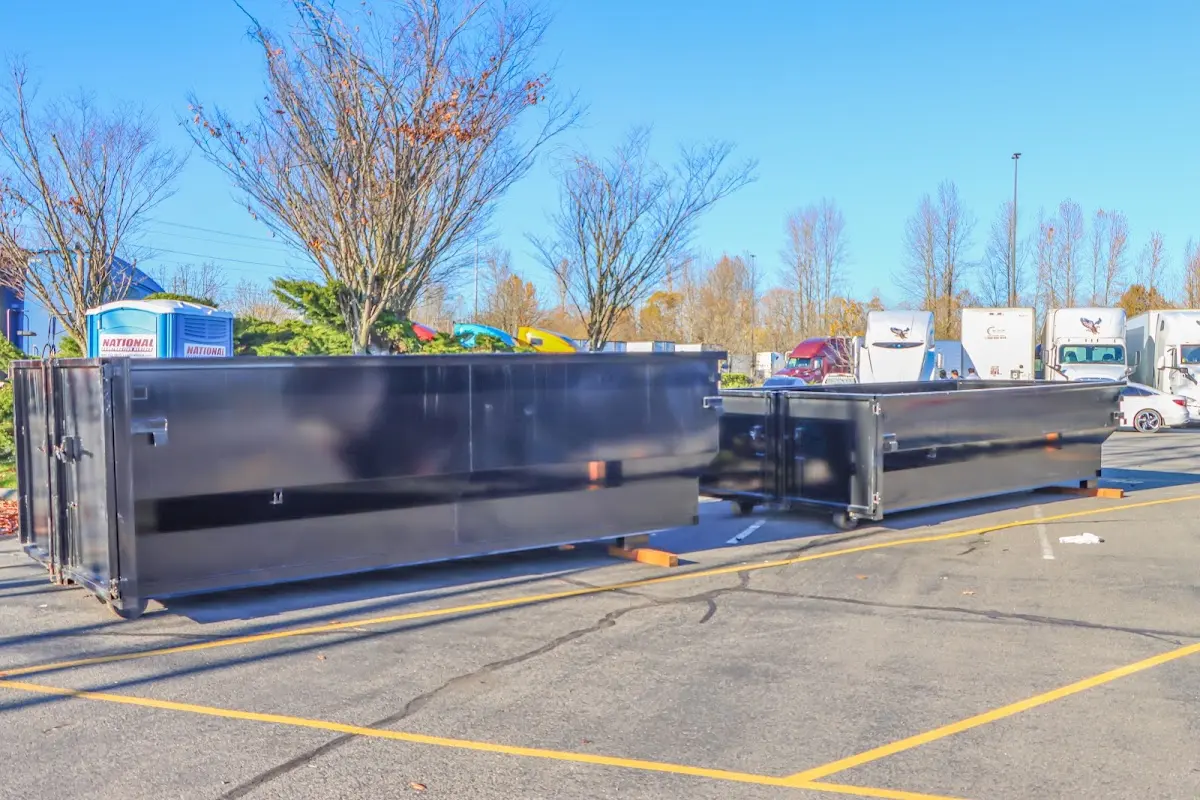 Professional dumpster rental service with roll-off container on residential driveway in Lake Holiday